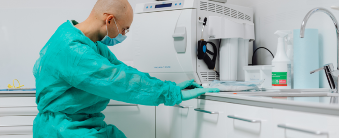 Orthodontic sterilization and records technician managing infection control equipment.